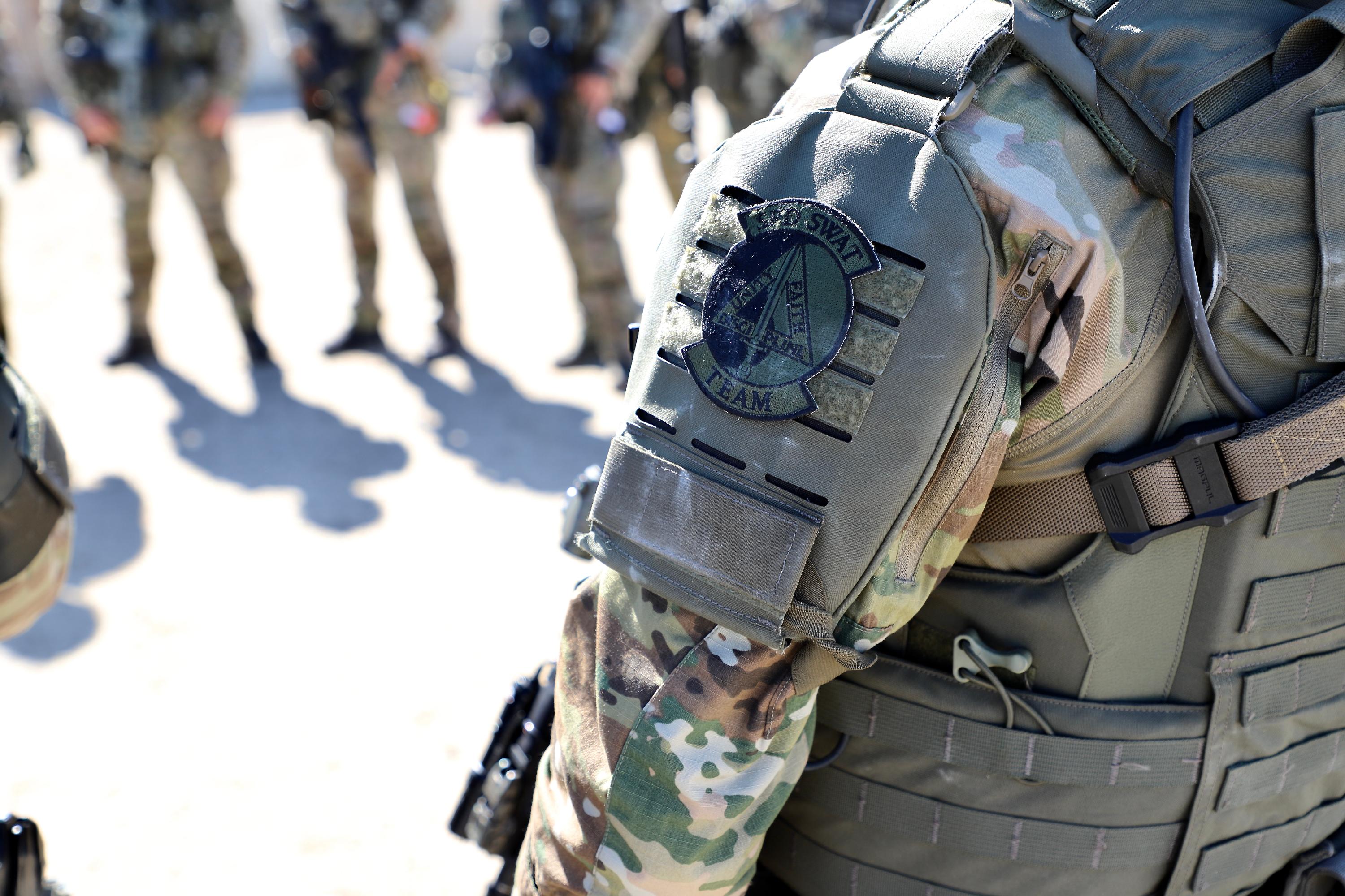 A soldier stands proudly in a military uniform